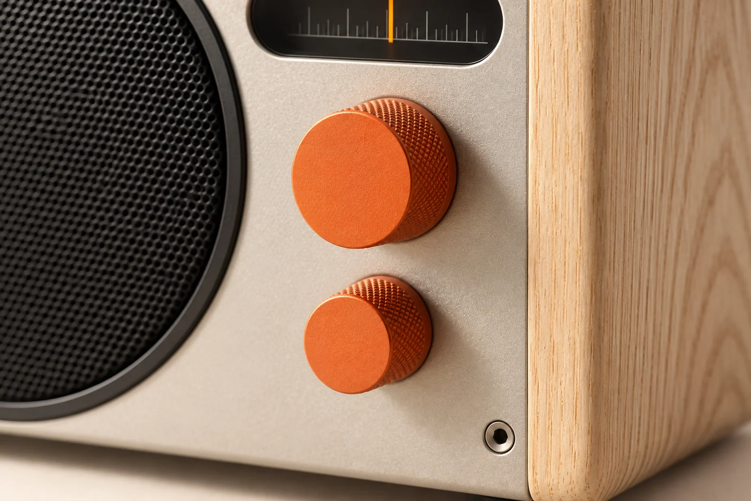 Close detail of PERCH’s orange knurled controls, satin aluminium and ash wood cheek