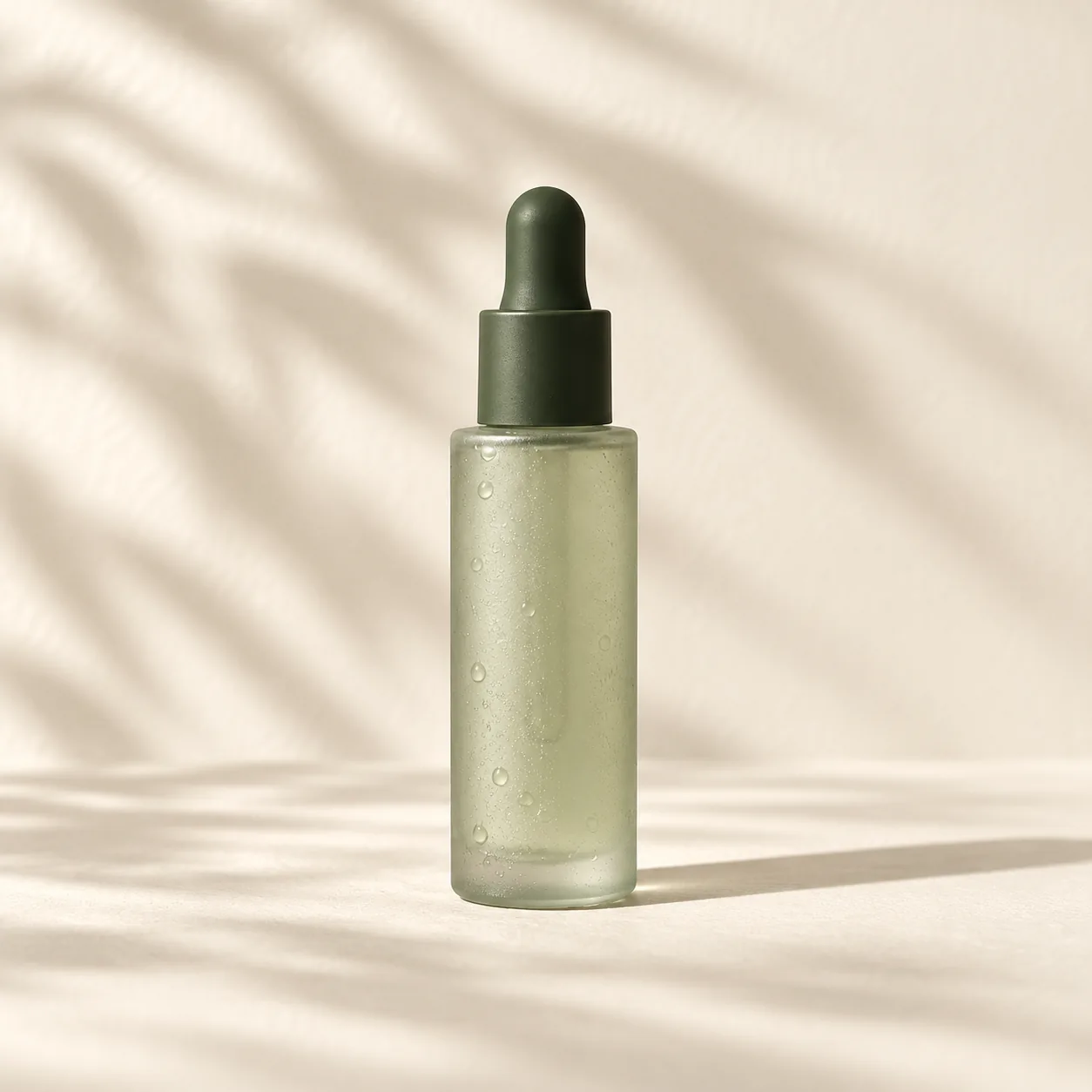 Hydration serum in frosted sage glass with an olive-green dropper